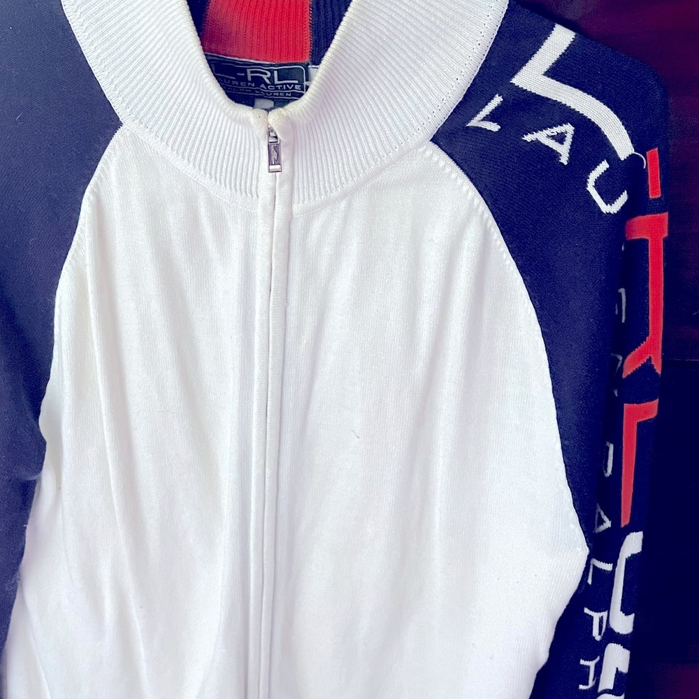 Women… White Lauren 2 way zip up sweater… With RL Lauren written down the arm.